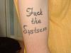 fuck-the-systsem-misspelled-tattoo.jpg